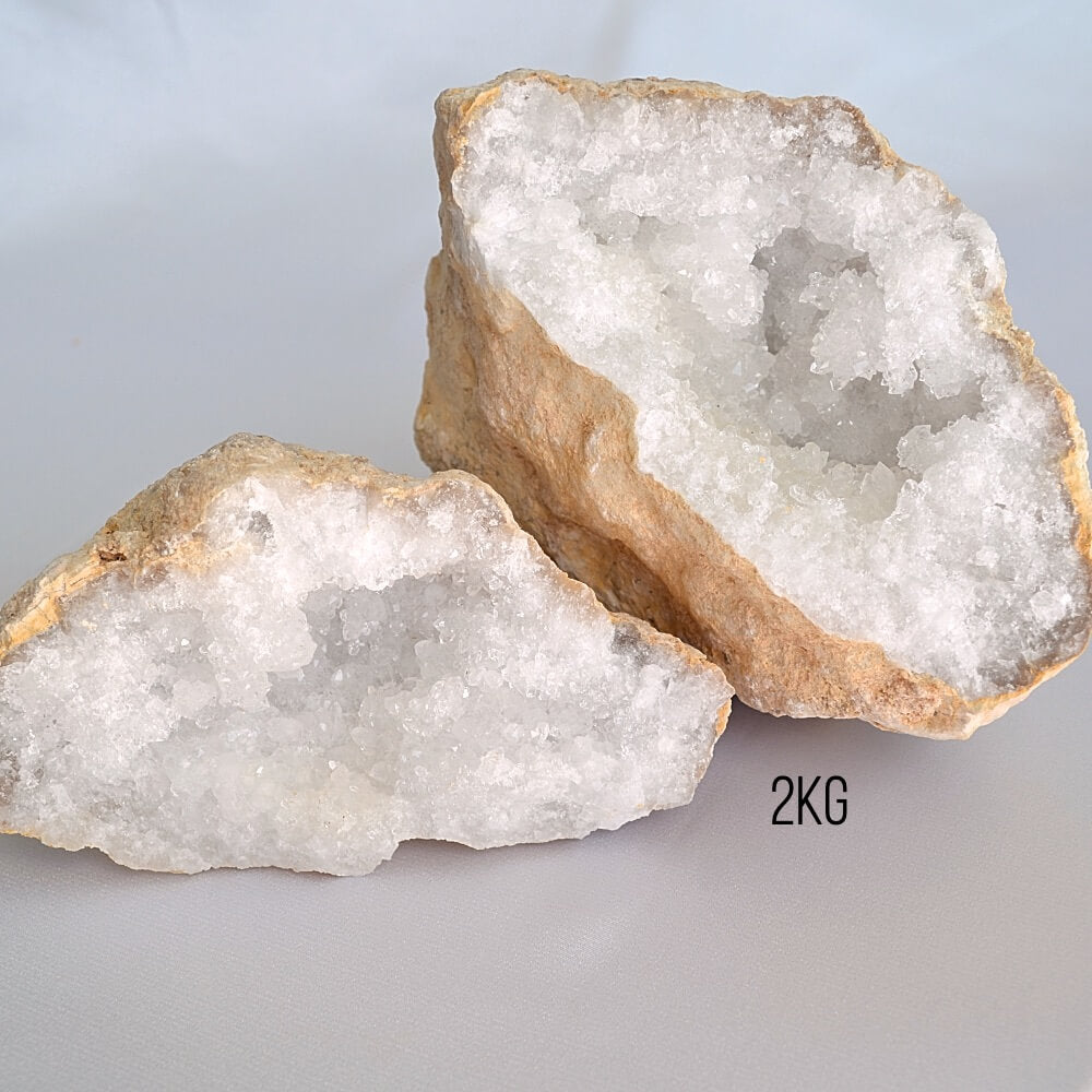 Two crystal geodes on a light gray background