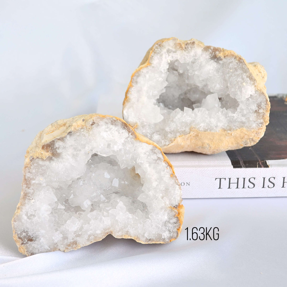 two crystal geodes, geode pair on book