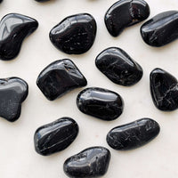 black tourmaline tumbled crystals white background