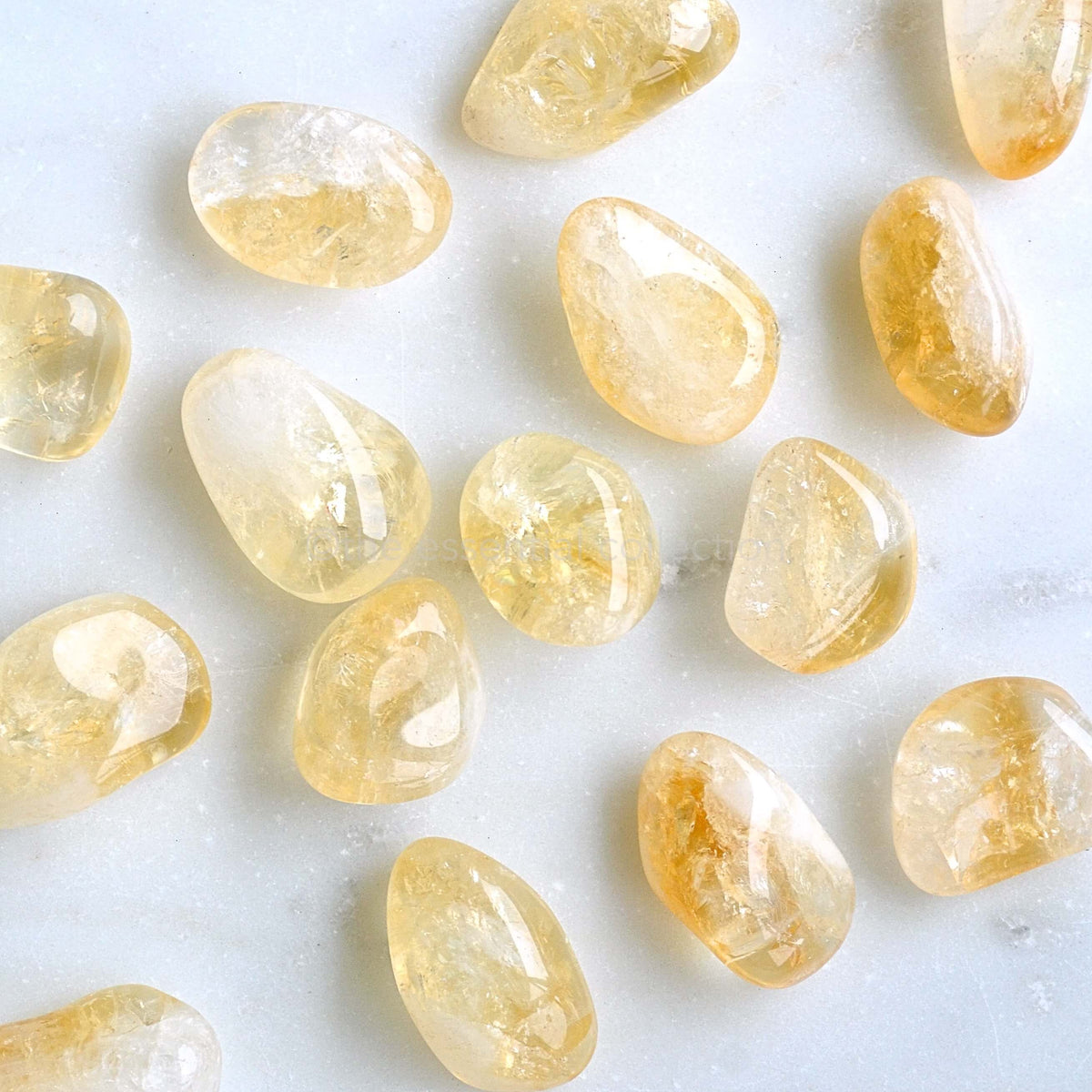 citrine tumbled crystals white background