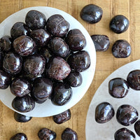 garnet tumbled crystal gemstones in white selenite bowl