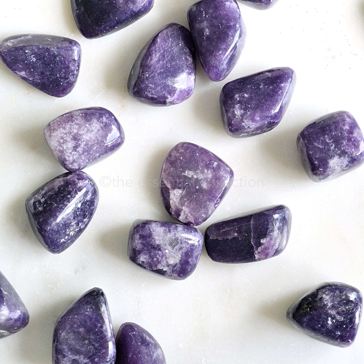 lepidolite tumbled crystals white background