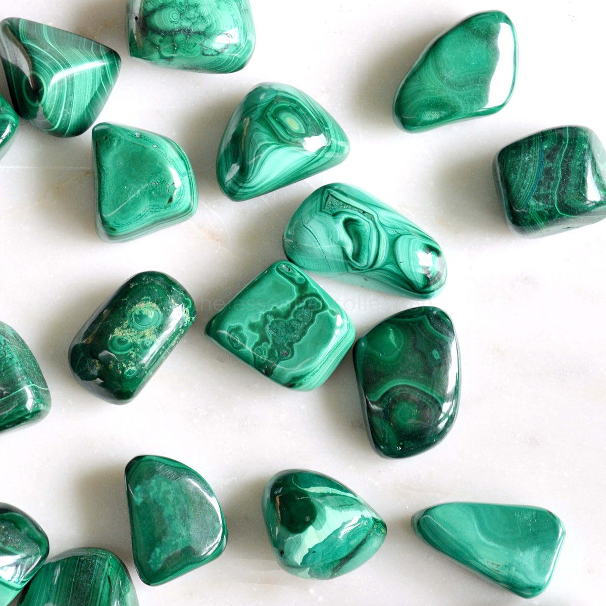 malachite tumbled crystals white background