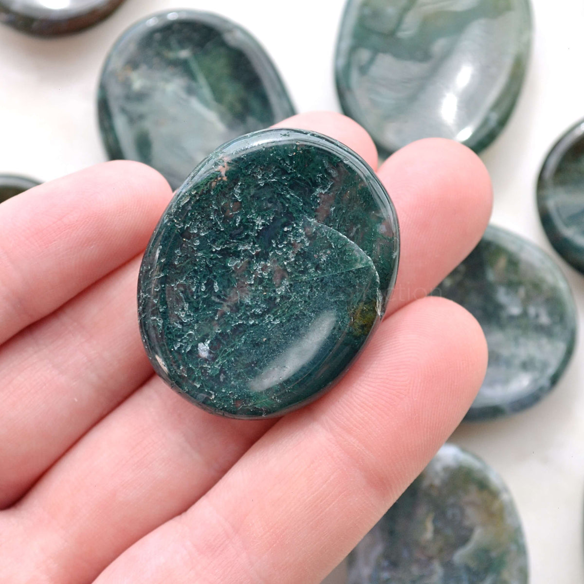 moss agate worry stone in hand