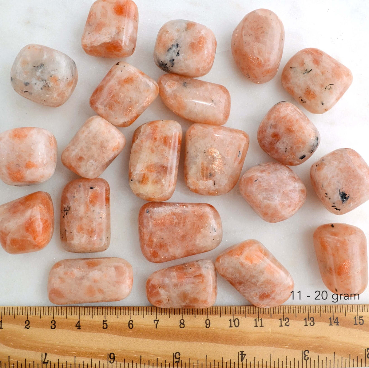 sunstone tumbled stones with ruler