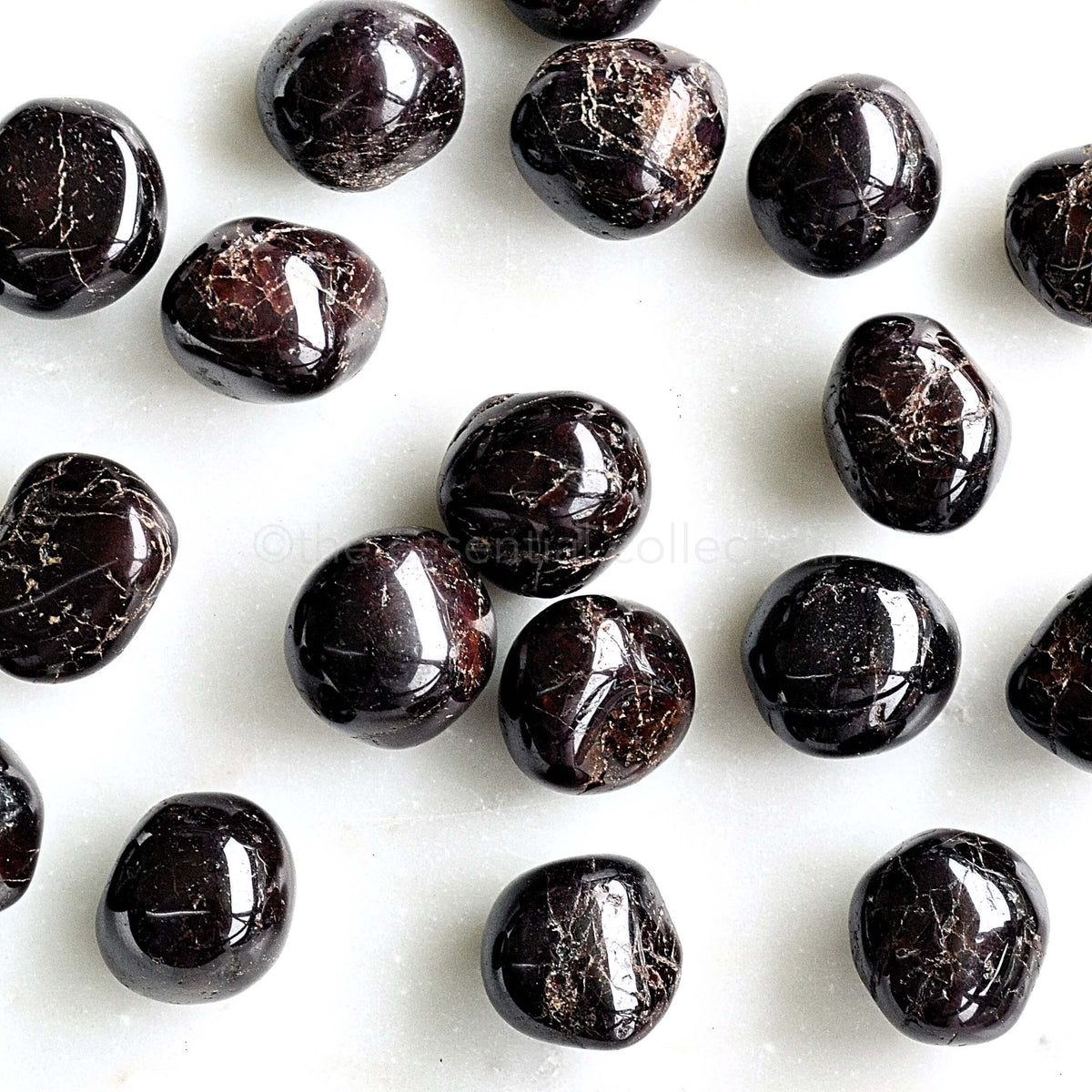 tumbled garnet crystals white background