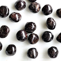 tumbled garnet crystals white background