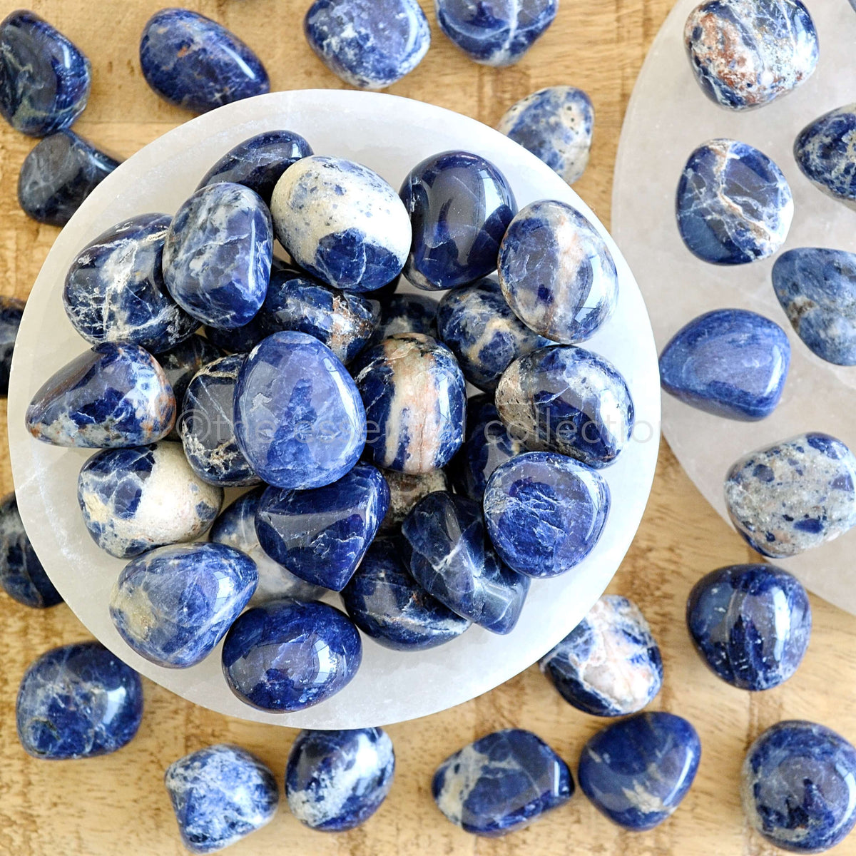 sodalite tumbled crystals in white selenite bowl blue and white gemstones sold by the essential collection australia