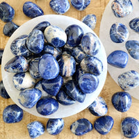 sodalite tumbled crystals in white selenite bowl blue and white gemstones sold by the essential collection australia