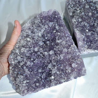 amethyst bookend pair in hand showing size, crystal home decor