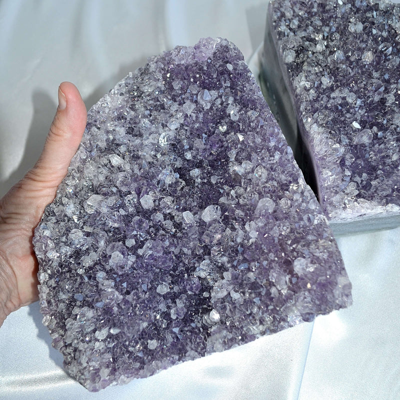 amethyst bookend pair in hand showing size, crystal home decor