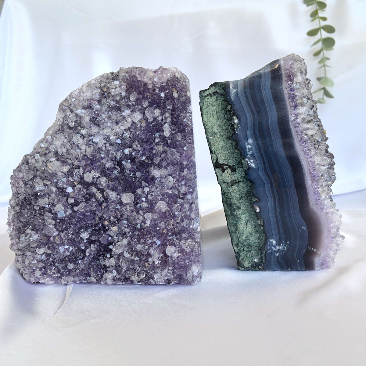 Two crystal bookends, one purple and one green and purple