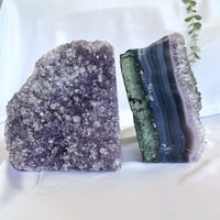 Two crystal bookends, one purple and one green and purple