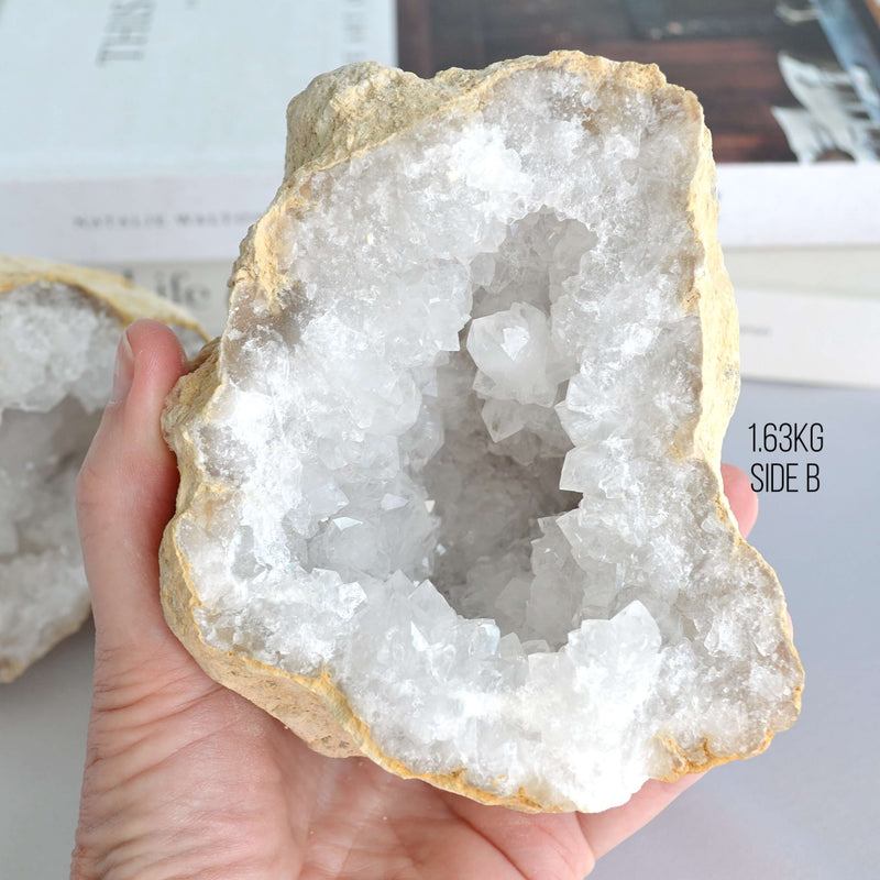 Hand holding a large crystal geode 