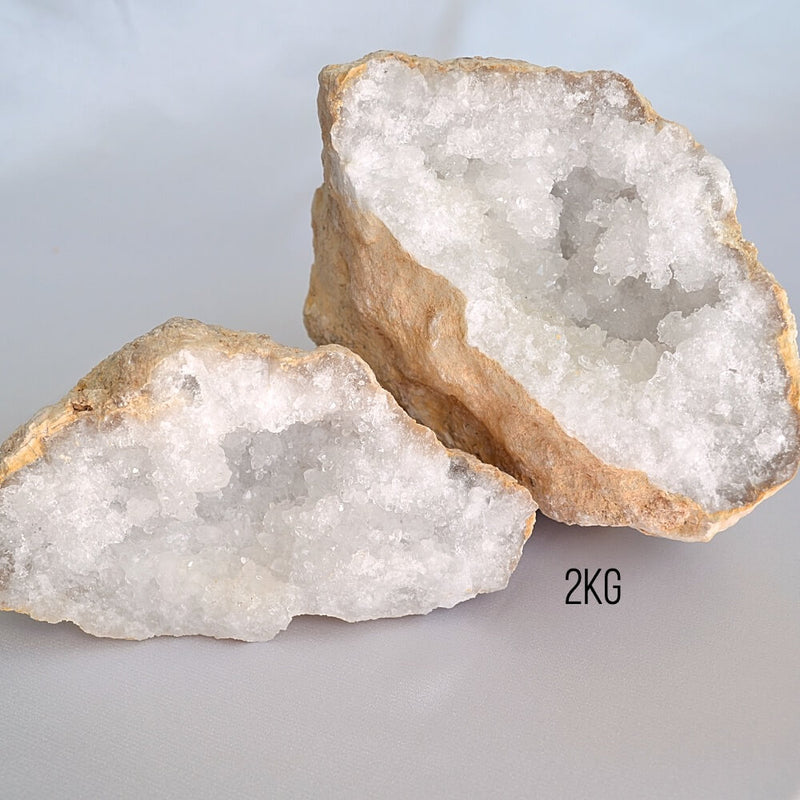 Two crystal geodes on a light gray background 