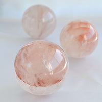 close up of fire quartz crystal sphere with red hematoid inclusions