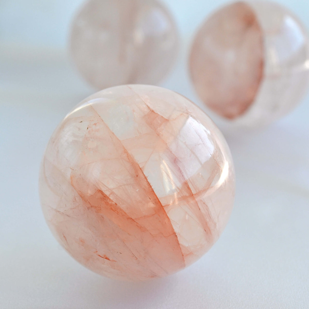 natural fire quartz crystal sphere with red orange lines