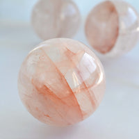 natural fire quartz crystal sphere with red orange lines
