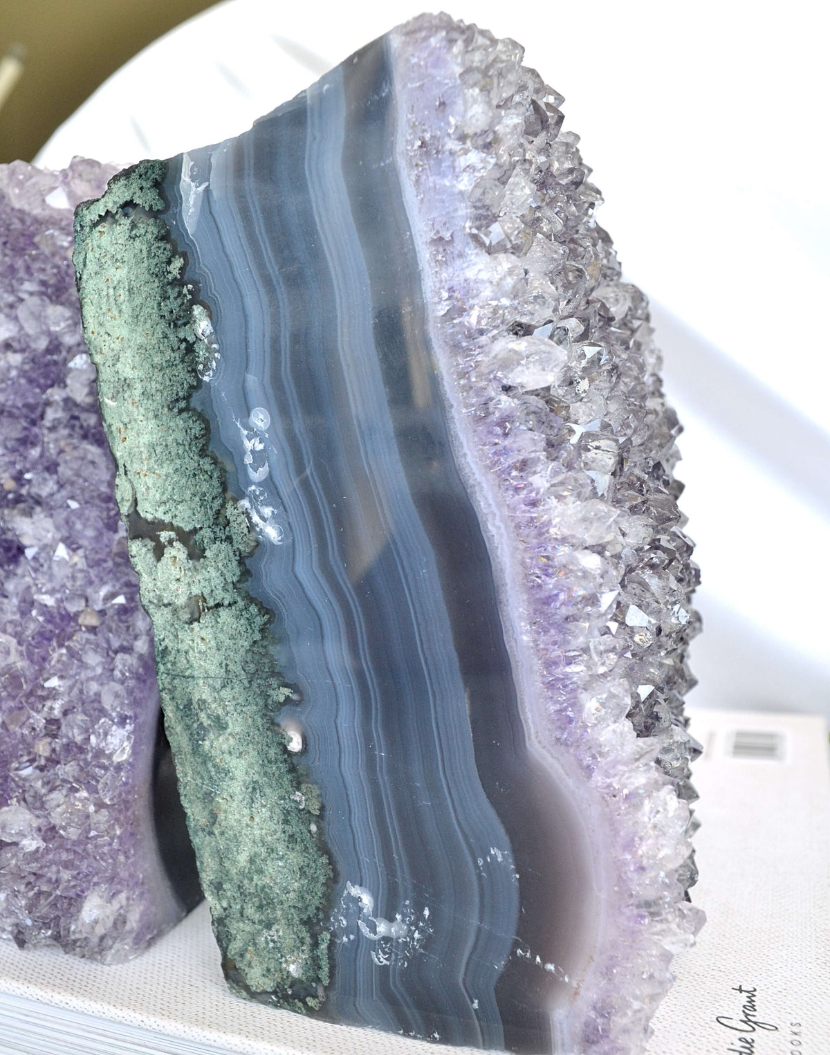 Close-up of a crystal geode with layered colors on a white background