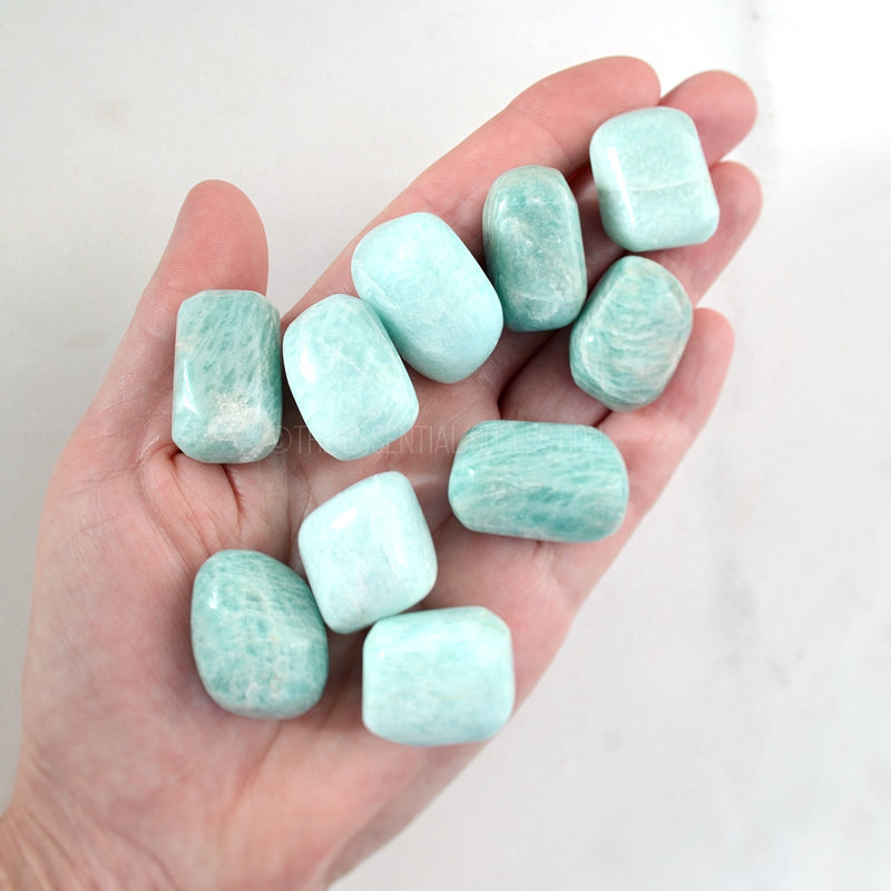 amazonite tumbled crystals in hand 
