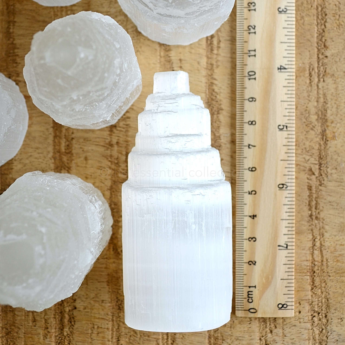white selenite tower 10cm tall with ruler showing height