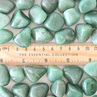 aventurine tumbled crystals with a wood ruler to show the size