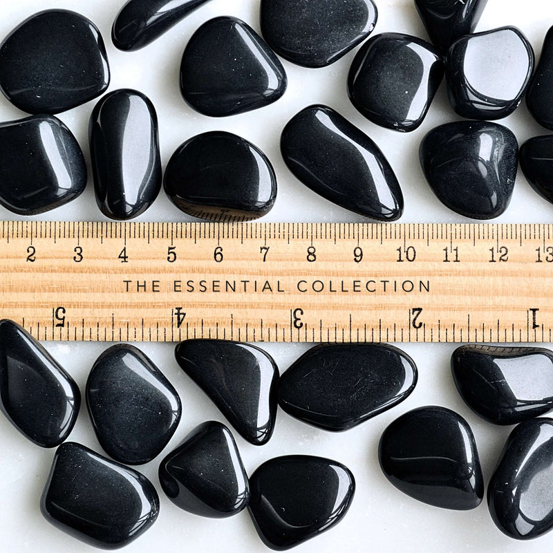 black obsidian tumbled crystals with ruler