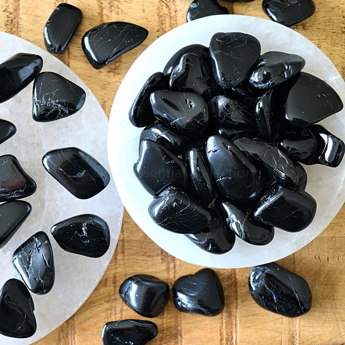 black tourmaline tumbled crystals in white selenite bowl
