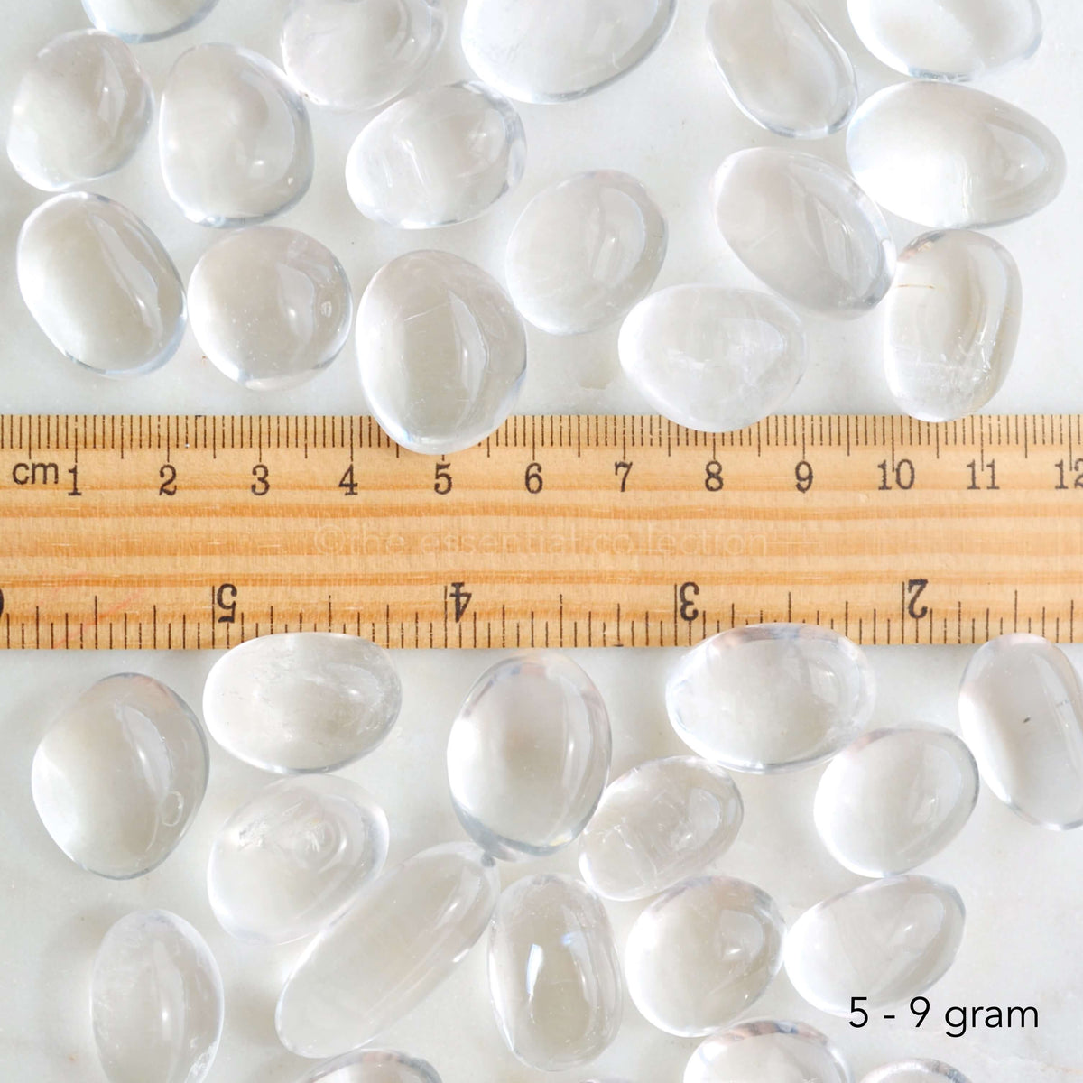 clear quartz tumbled crystals with ruler