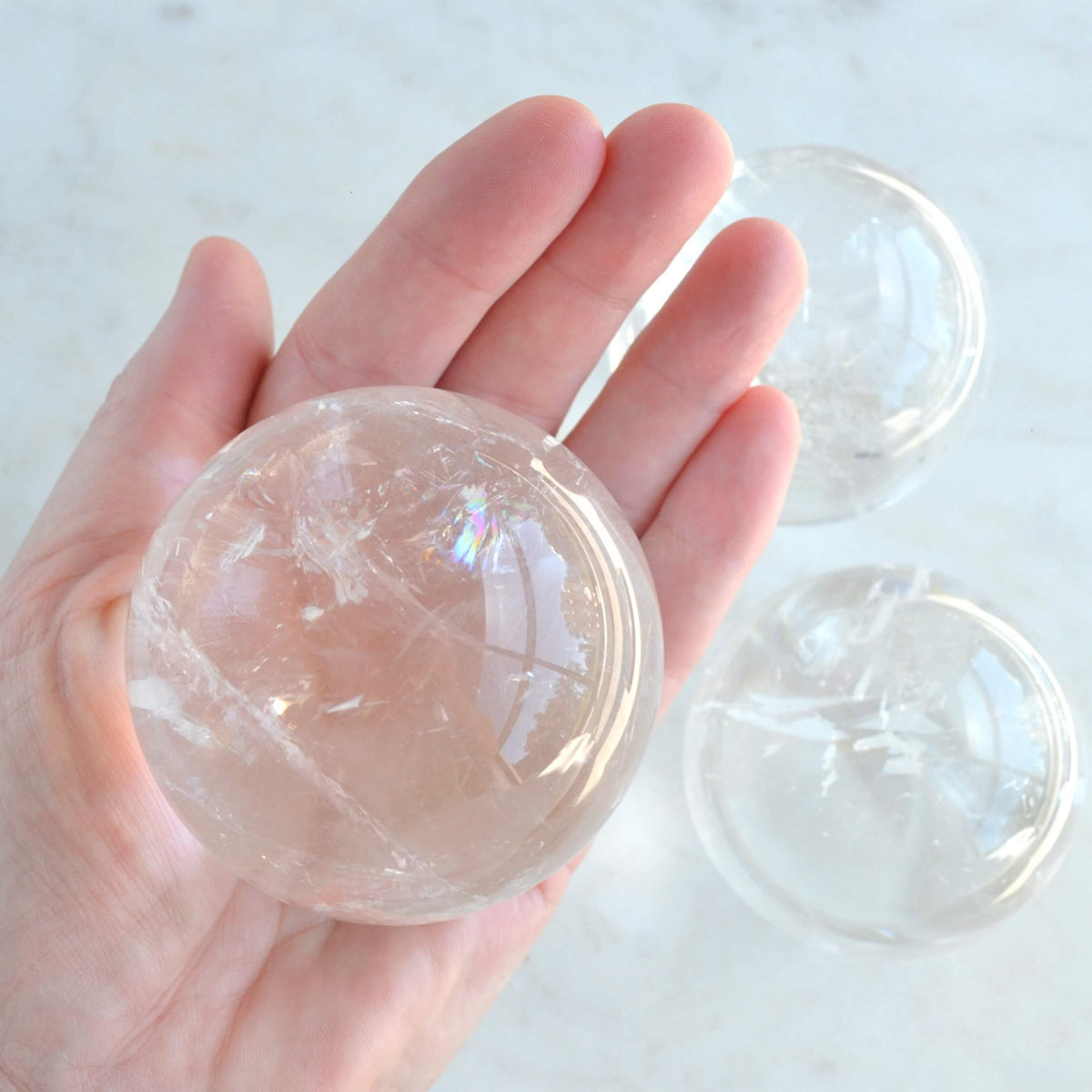 clear quartz sphere in hand