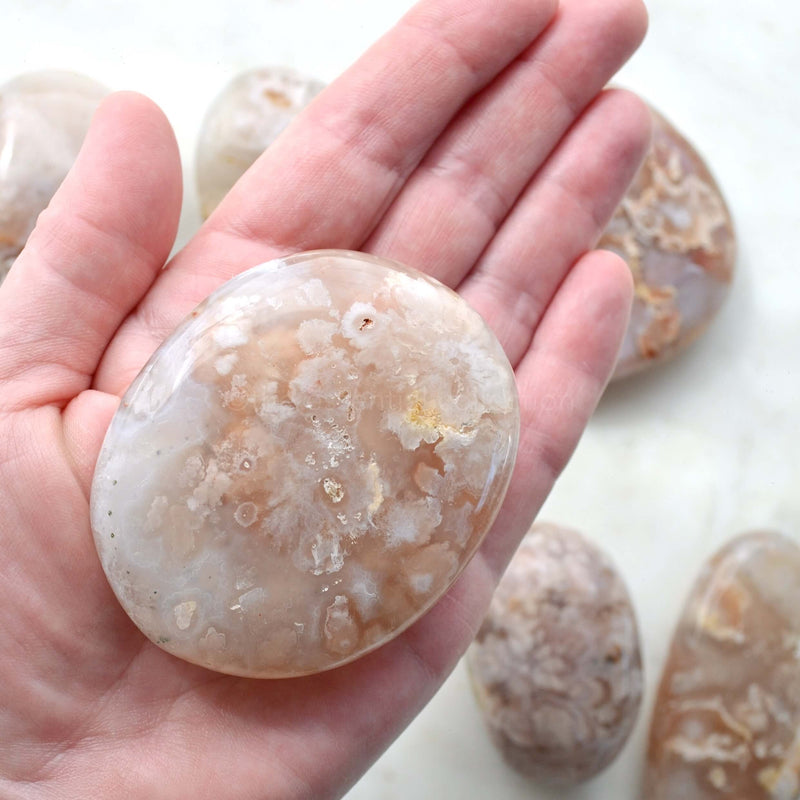 flower agate palm stone in hand