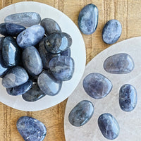 iolite tumbled crystals in white selenite bowls and on white selenite plate