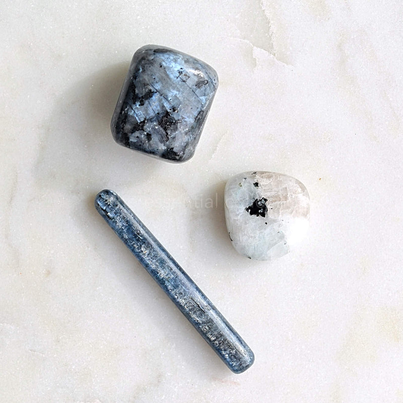 blue kyanite rainbow moonstone larvikite crystals white background