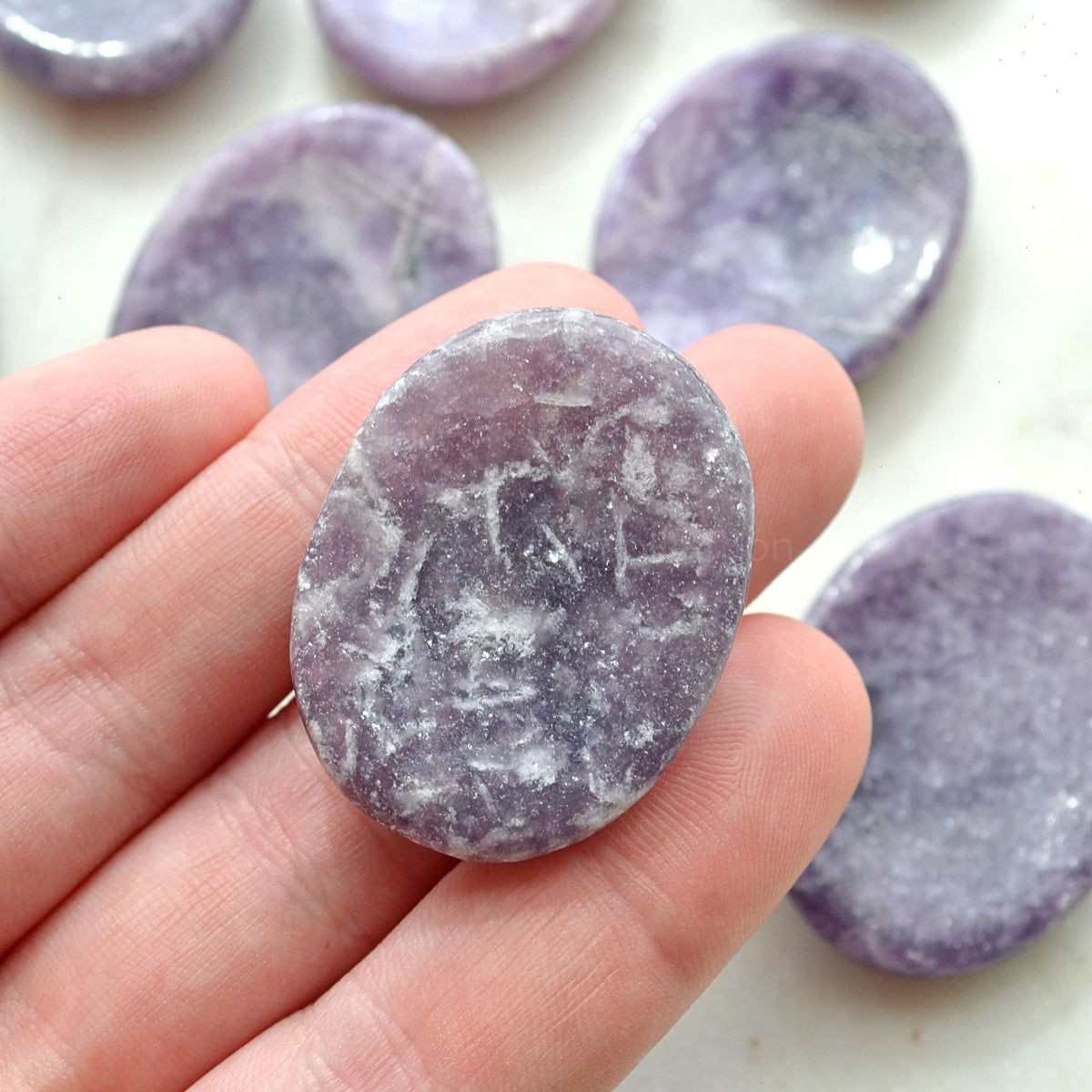 lepidolite worry stone in hand
