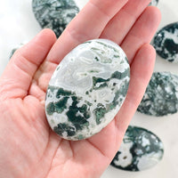 moss agate palm stone in hand
