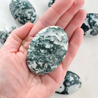moss agate palm stone in hand