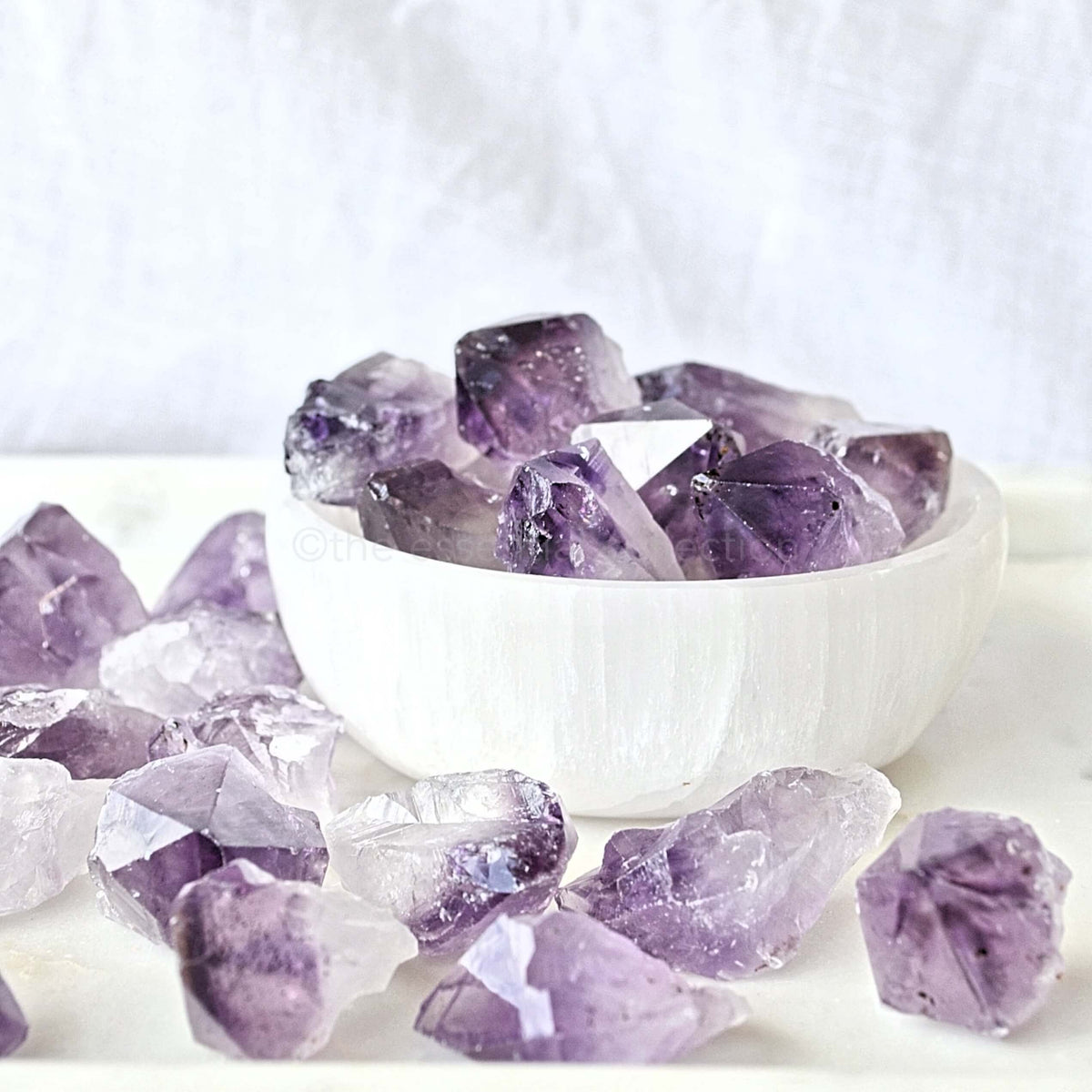 natural amethyst crystal points in selenite bowl