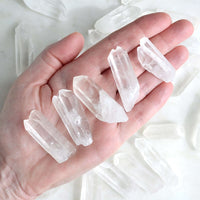 raw clear quartz points in hand