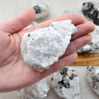 large rainbow moonstone raw crystal in hand