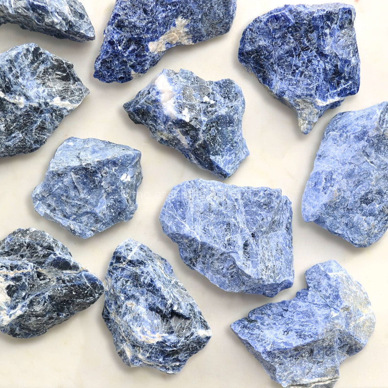 raw sodalite crystals blue white background