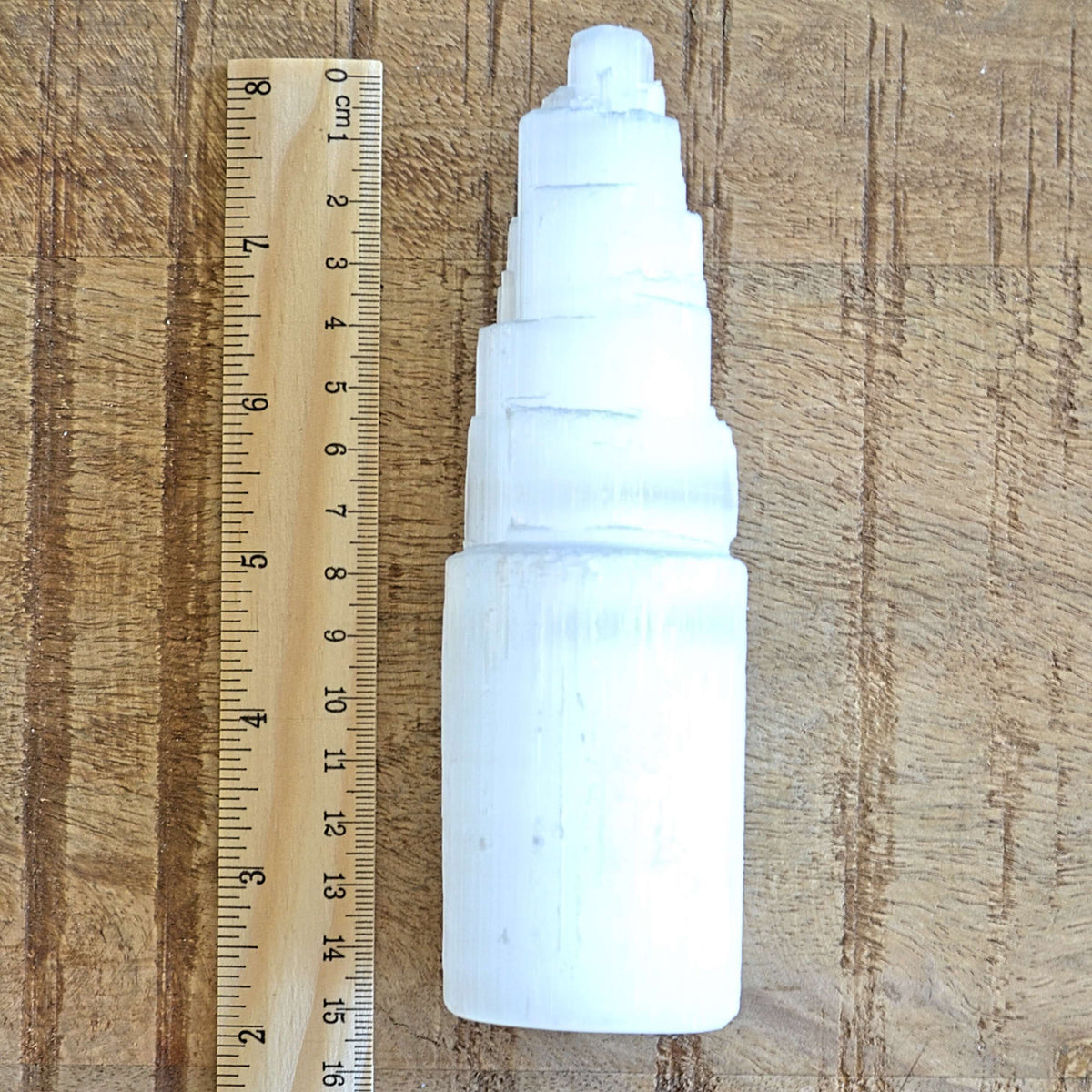 white selenite tower with ruler showing height