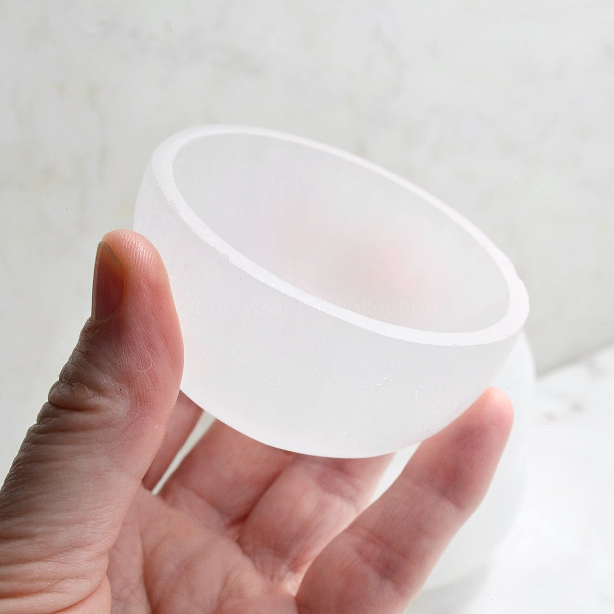 white selenite trinket bowl in hands