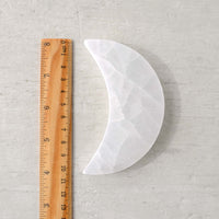 small selenite moon with ruler