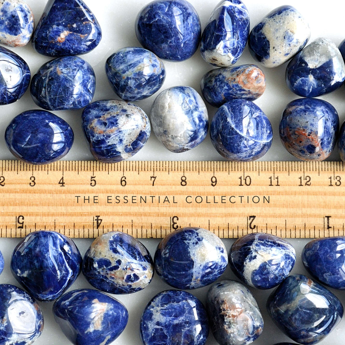 tumbled sodalite crystals with ruler showing size
