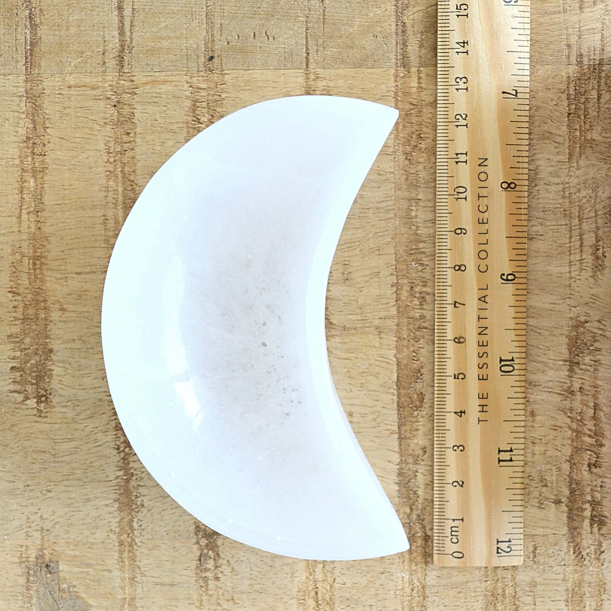 white crescent moon selenite charging bowl with ruler